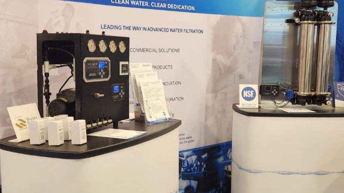Aquamor trade-show booth with white-and-blue branding and filtration systems on display at the National Restaurant Association Show